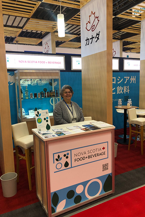 Invest Nova Scotia's Omaira Ospino stands at the Nova Scotia Food+Beverage booth during FoodEx Japan 2023 trade show.