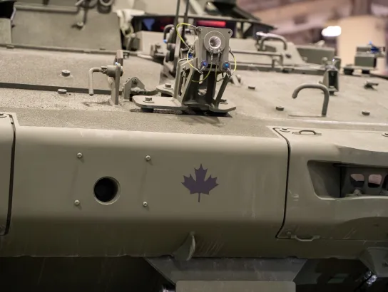 Close up of Canadian flag symbol on armoured vehicle.