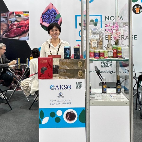 Woman at food show exhibiting AKSO Marine products