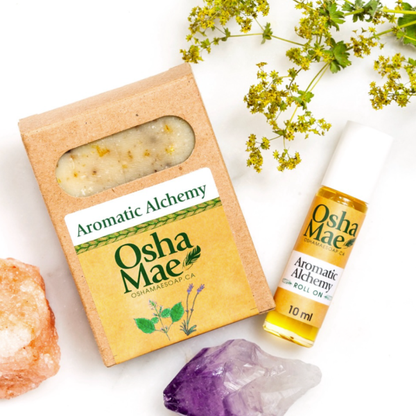 Soap and aromatherapy oil displayed with crystals and foliage