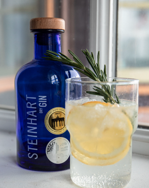 Blue Gin bottle, with glass beside it