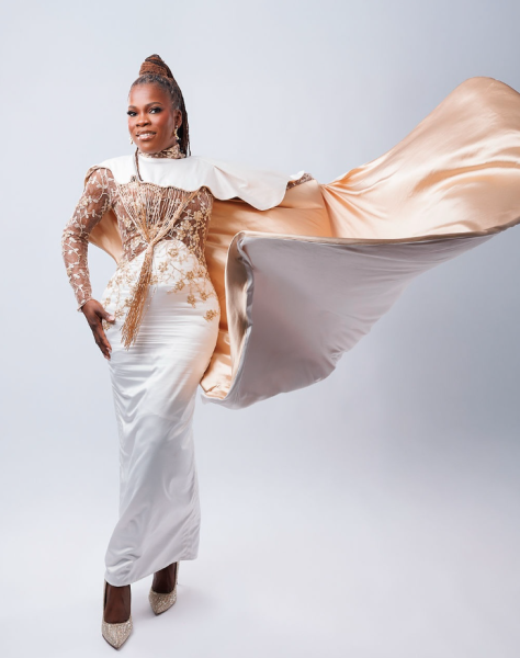 Woman dressed in an ivory gown with a cape