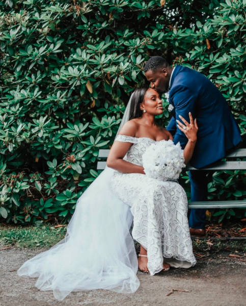 Bride and groom seated on a bench