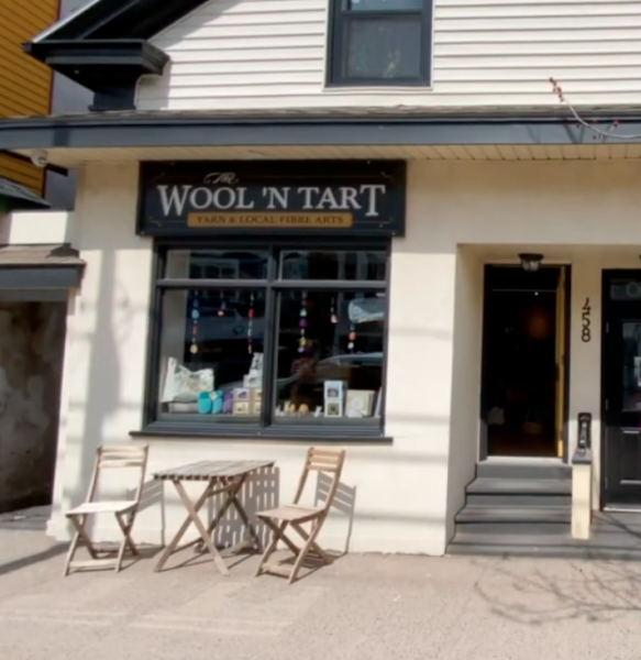 Storefront of Wool 'N Tart with bistro set in front