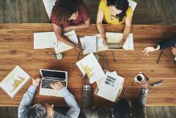 High angle shot of a team of businesspeople meeting around the boardroom table in the office