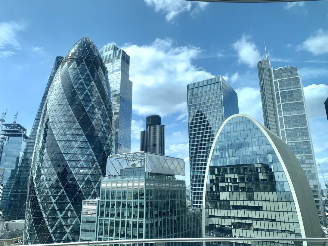 London, England: Shiny glass buildings on blue cloud day in London