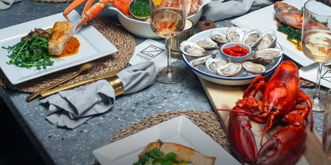 Nova Scotia Seafood - Lobster, Crab, Oysters, Salmon plated on a table